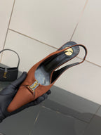 Tan slingback heel showing curved strap and gold logo buckle