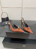 Tan pointed-toe slingback pumps with stiletto heels and gold buckle logo on straps