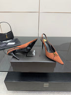 Tan slingback pump, pointed toe, stiletto heel, gold logo buckle on strap