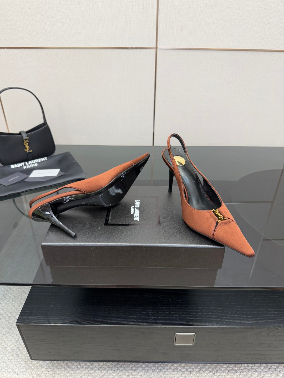 Tan slingback pump, pointed toe, stiletto heel, gold logo buckle on strap