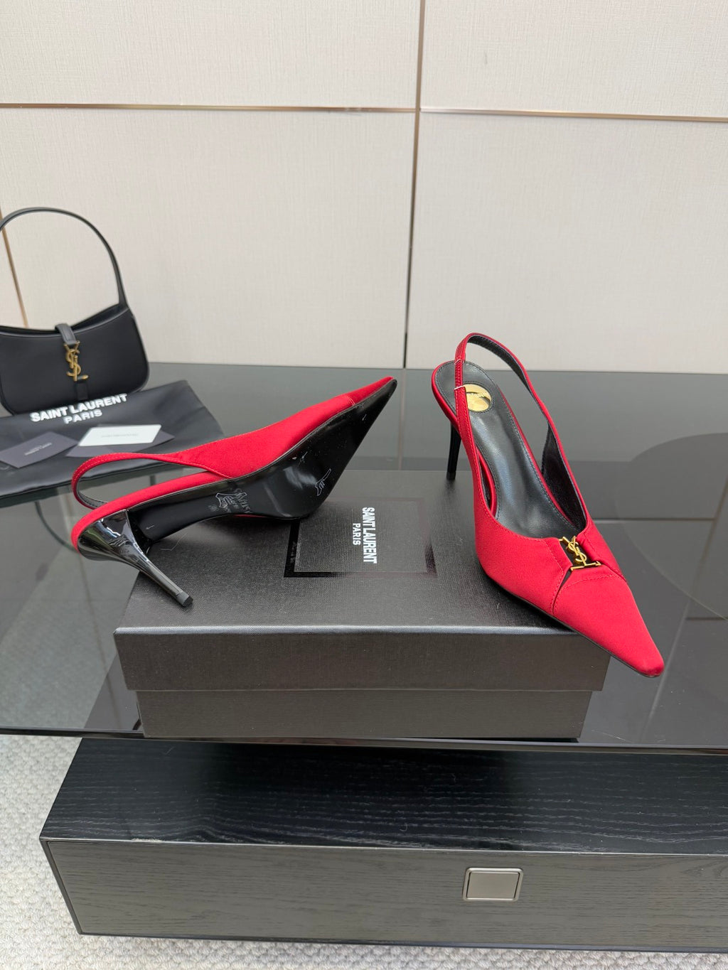 Women’s red slingback heels, angled side view with YSL emblem