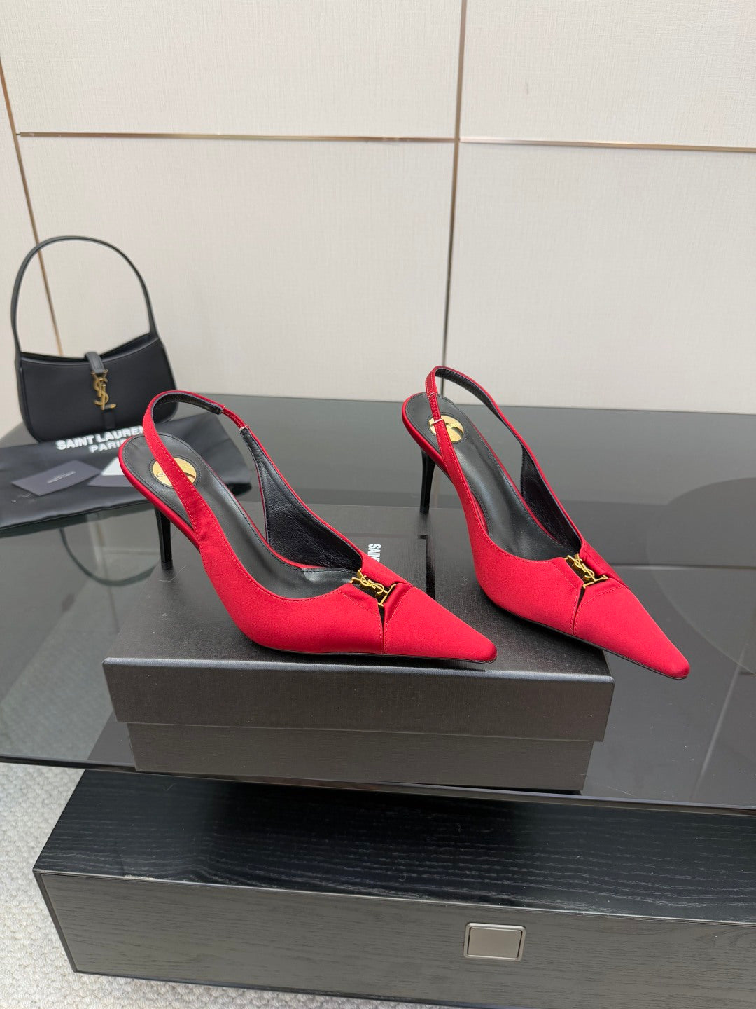 Women’s red slingback heels with YSL gold logo at the vamp