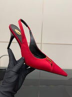Women’s red stiletto slingback heels, hand-held close view