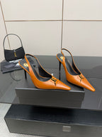 Women's orange pointed-toe stiletto heels, angled pair, gold buckle detail