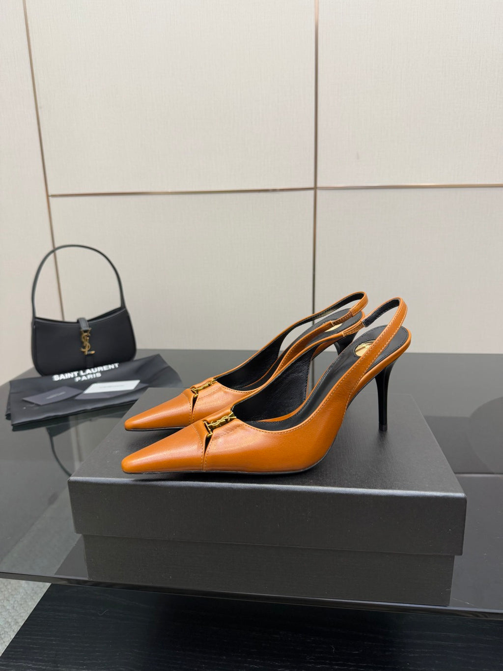 Women's orange pointed-toe stiletto heels, side view, gold buckle detail