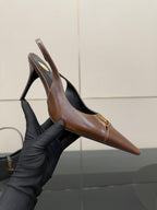 YSL ladies pointed-toe heel held in hand, brown with gold emblem, slingback