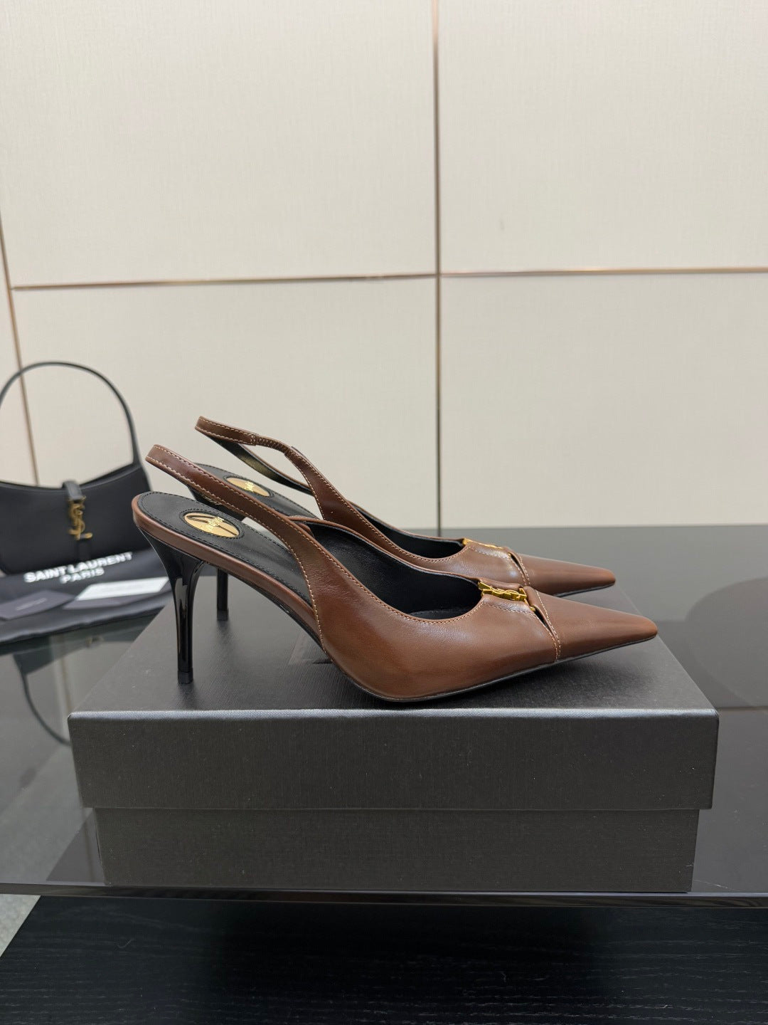 YSL ladies pointed-toe slingback heels, brown with black lining, angled view