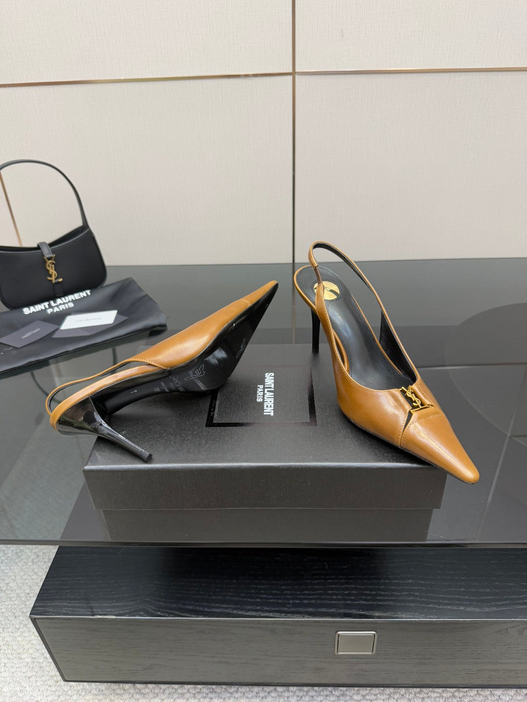 YSL ladies' tan and dark high heels, heel-to-toe view on a display box