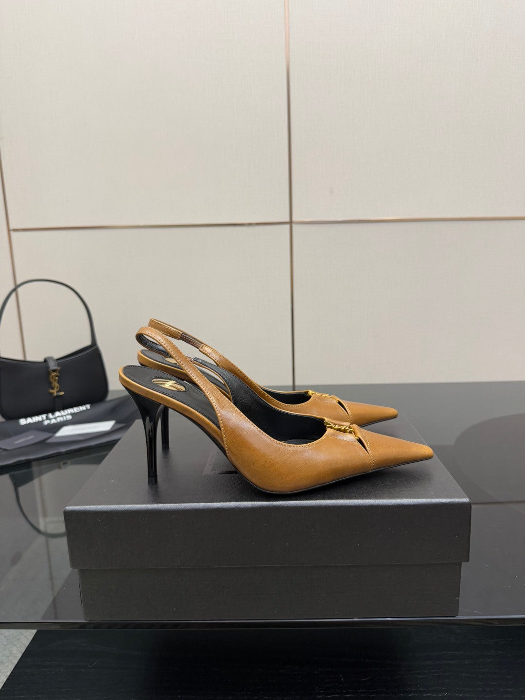 YSL ladies' tan pointed-toe high heels, angled side view with thin stiletto heel