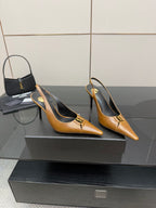 YSL ladies' tan pointed-toe high heels on a display platform, stiletto heel visible