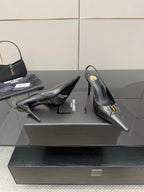 YSL ladies black pumps showing heel and side with gold logo strap