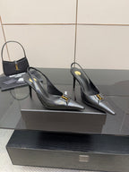 YSL ladies black pointed-toe pumps with gold logo buckle detail