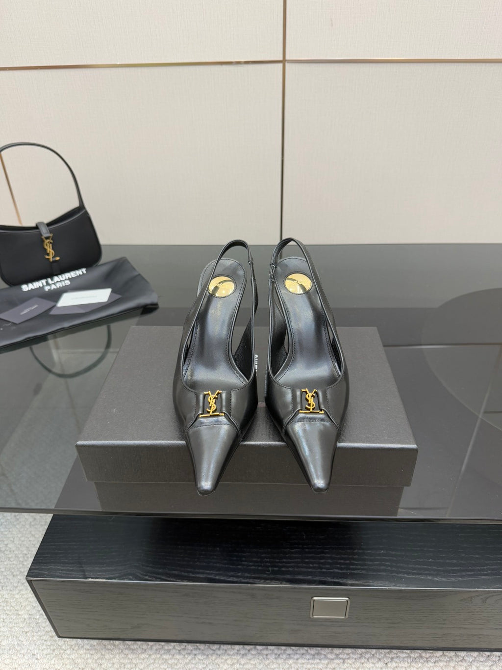 YSL ladies black pointed-toe pumps with gold logo accent strap on vamp