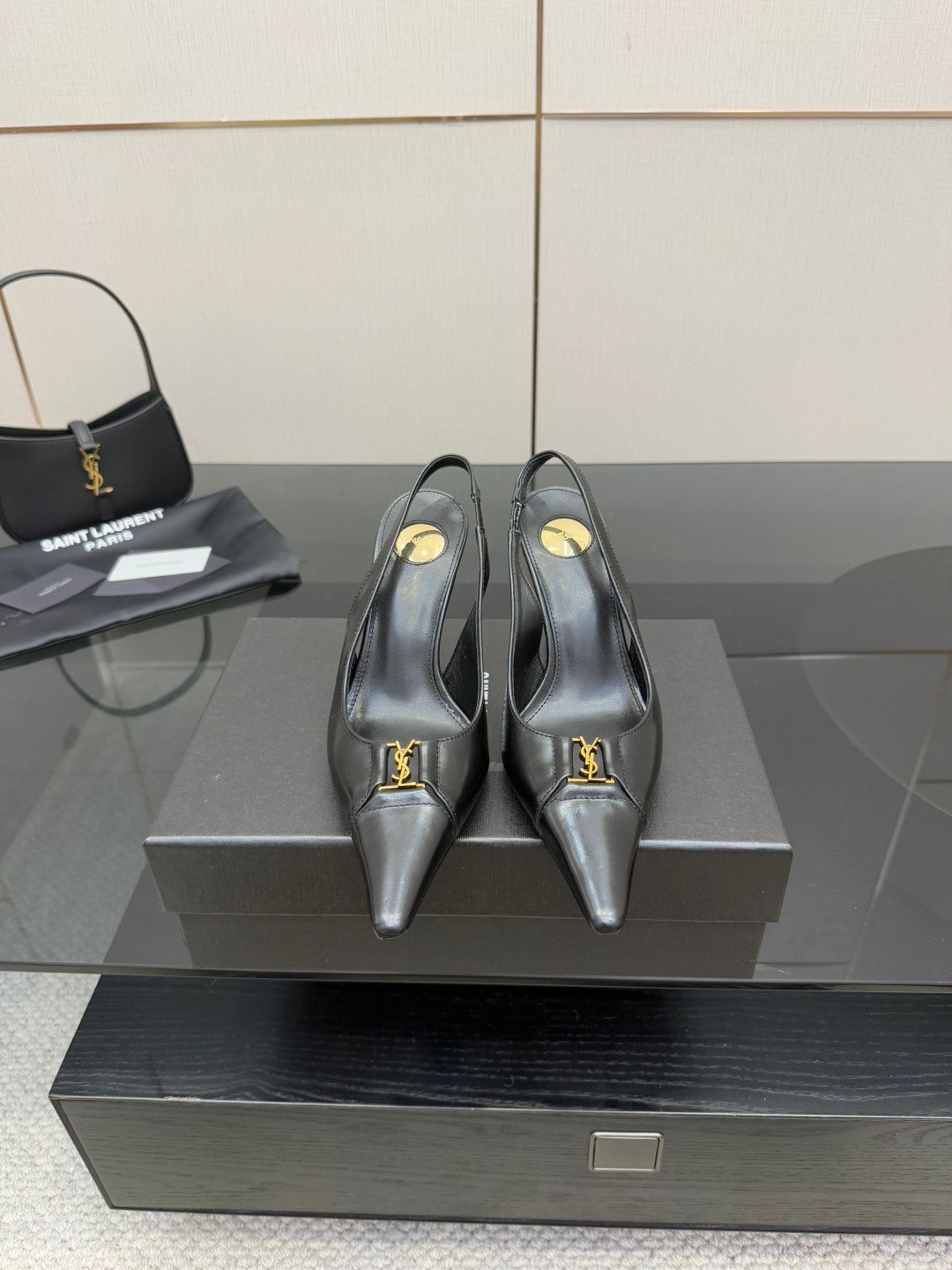 YSL ladies black pointed-toe pumps with gold logo accent strap on vamp