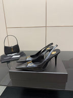 YSL ladies black slingback pumps on display with gold logo detail at toe