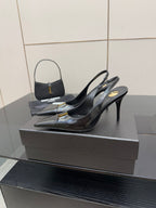 Black YSL slingback pumps with pointed toe and stiletto heel, glossy gold logo