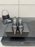 Black YSL slingback pumps with pointed toe and stiletto heel, gold logo detail