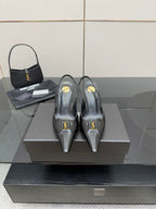 Black YSL slingback pumps with pointed toe and stiletto heel, gold logo detail