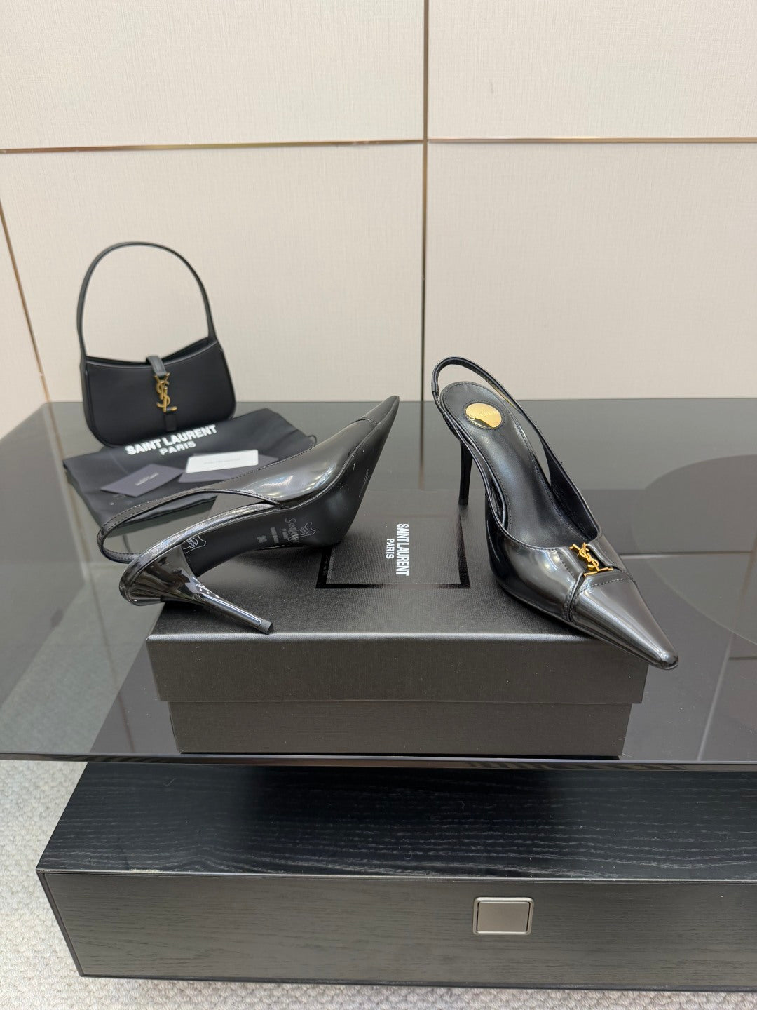 Black YSL slingback pumps with pointed toe, stiletto heel, glossy leather finish