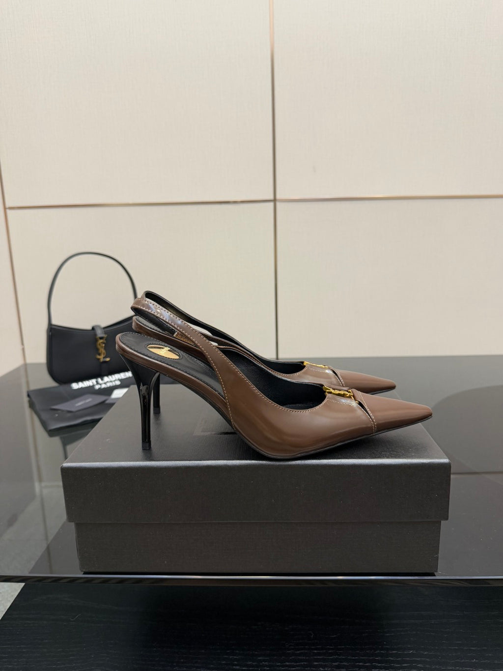 Brown leather pointed-toe slingback pump with slim high heel and gold trim