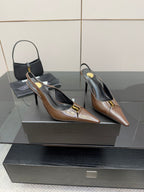 Pair of brown leather pointed-toe slingback heels with gold logo accents