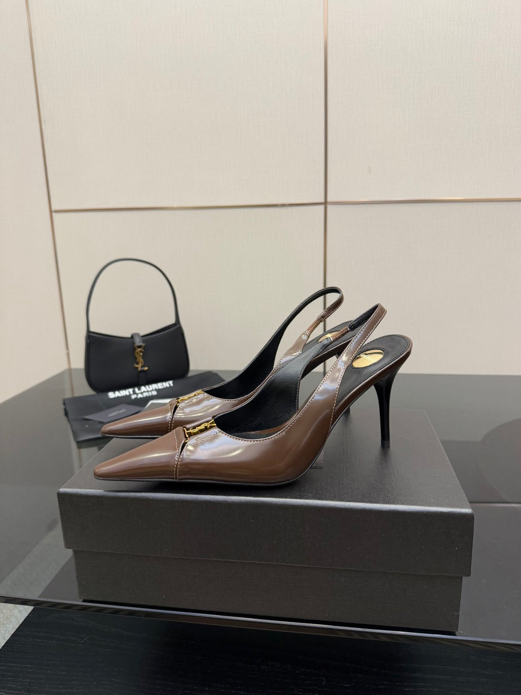 Brown leather slingback pumps on black heels, pointed toe and gold trim