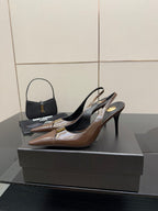 Brown leather slingback pumps on black heels, pointed toe and gold trim