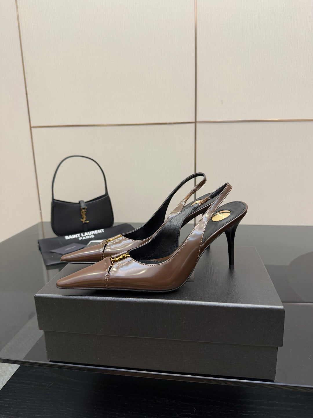 Brown leather slingback pumps on black heels, pointed toe and gold trim