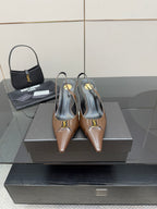 Brown leather pointed-toe slingback heels with gold logo detail