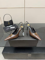 Brown leather slingback pumps with pointed toe and gold logo detail