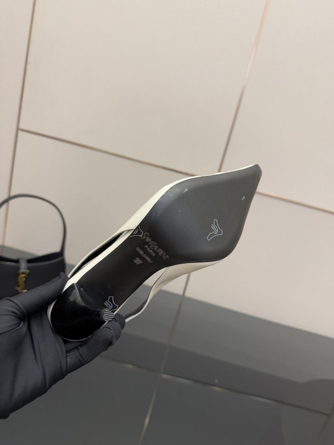 White slingback heel bottom/sole side view with printed logo on inner lining.
