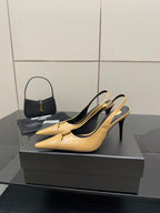YSL beige patent slingback pump with pointed toe and black lining, side view