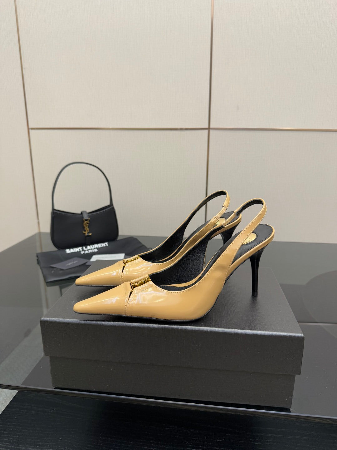 YSL beige patent slingback pump with pointed toe and black lining, side view