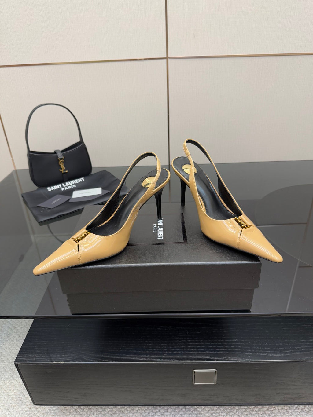 YSL beige patent slingback heels pair on display with black insoles