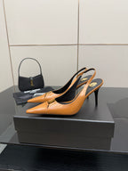 Women’s orange pointed-toe slingback pumps on a black display box, stiletto heel