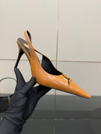 Women’s orange pointed-toe slingback pump in hand with stiletto heel and logo