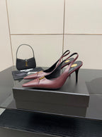 Burgundy pointed-toe slingback high heels on display, gold logo detail