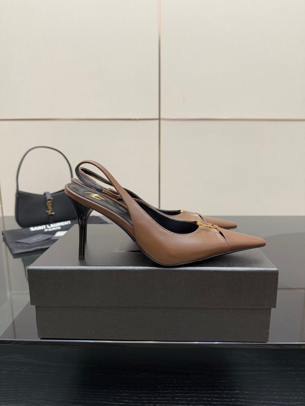 Brown pointed-toe slingback pump on its side profile, high heel visible