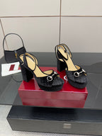 Pair of black velvet heeled sandals with silver ring detail and thick block heel