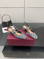 Front pair of blue GG monogram flats with bow buckle and slingback strap