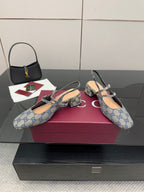 Two blue GG monogram flats with bow buckle and slingback strap, angled view
