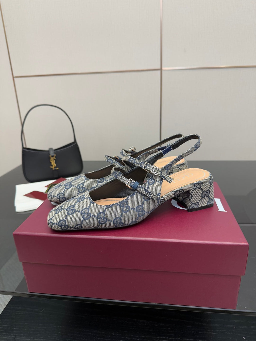 Side view of blue GG monogram flats with bow buckle and slingback strap