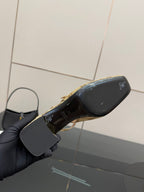 Gucci heeled mule outsole view with black sole and gold branding