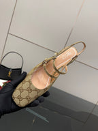 Gucci GG-pattern slingback mule held near toe, showing inner lining