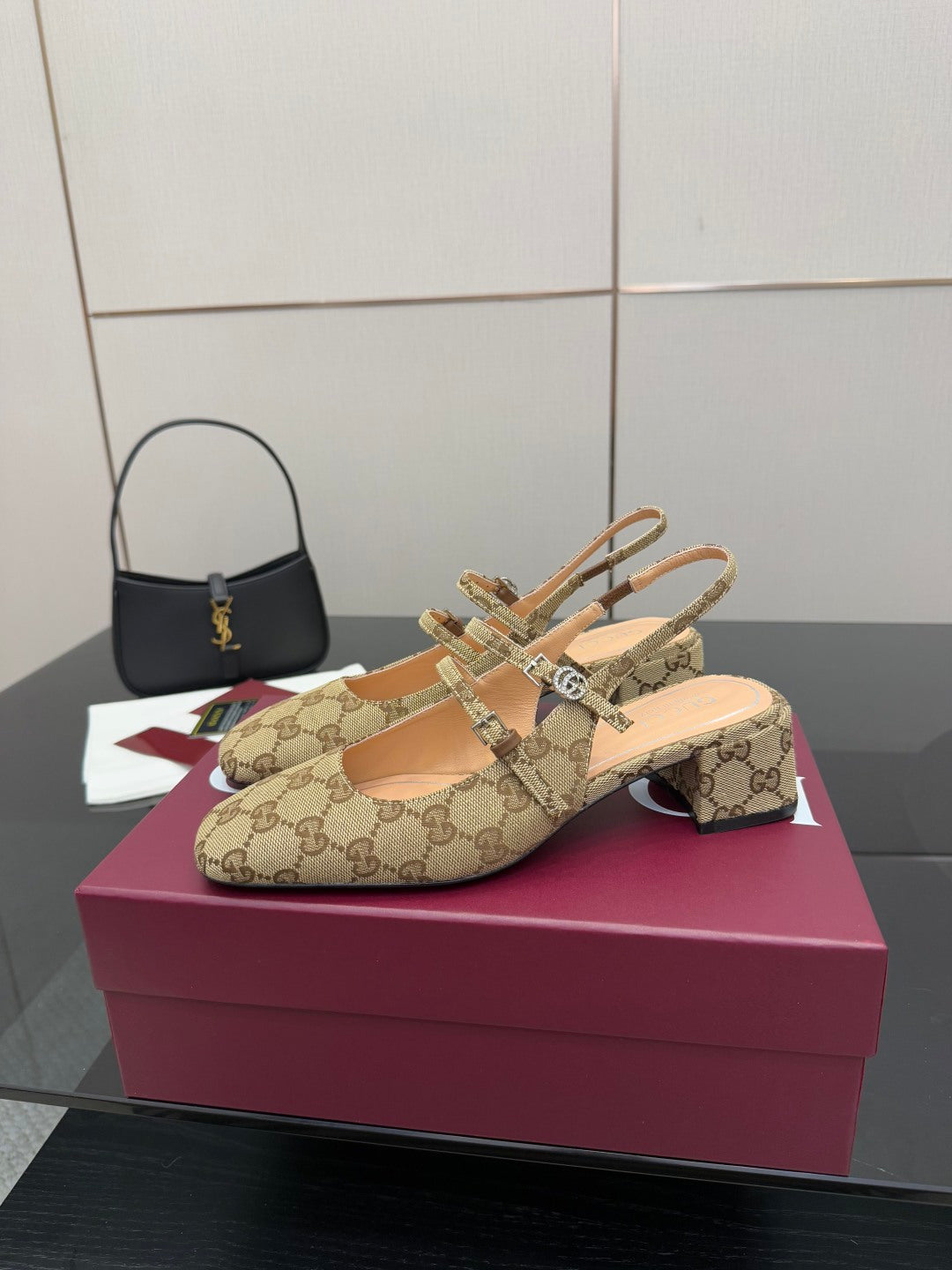 Gucci GG-pattern heeled mule with crisscross strap and gold-toned hardware