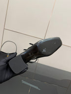 Black patent heel sole with small logo, underside view