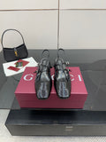 Black patent slingback heels with buckle strap and low block heel, pointed toe