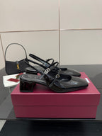 Black patent slingback heels with front strap and logo buckle, block heel