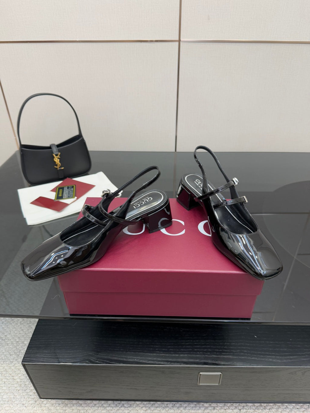 Black patent slingback heels with glossy finish, pointed toe and block heel