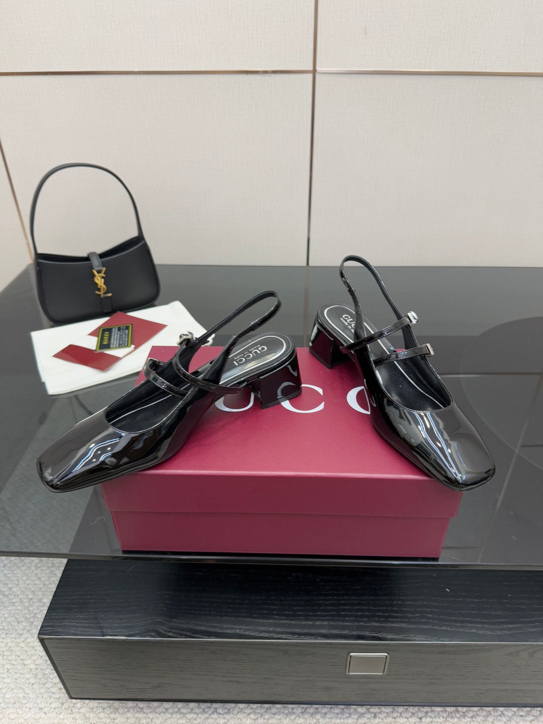 Black patent slingback heels with glossy finish, pointed toe and block heel